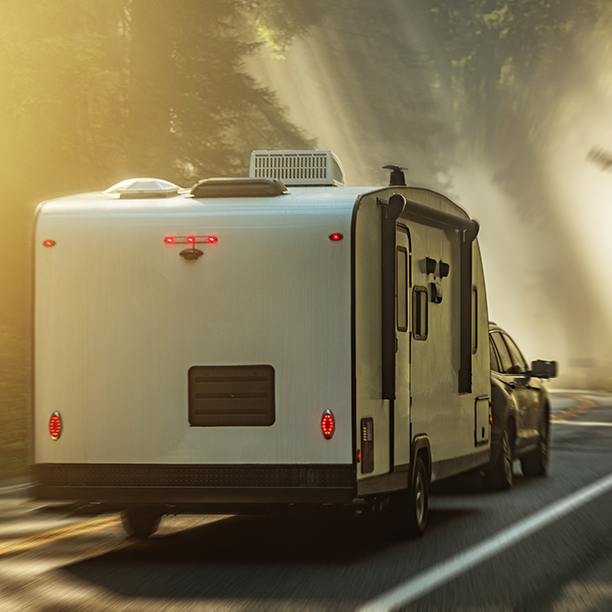 a camper trailer being towed behind a truck