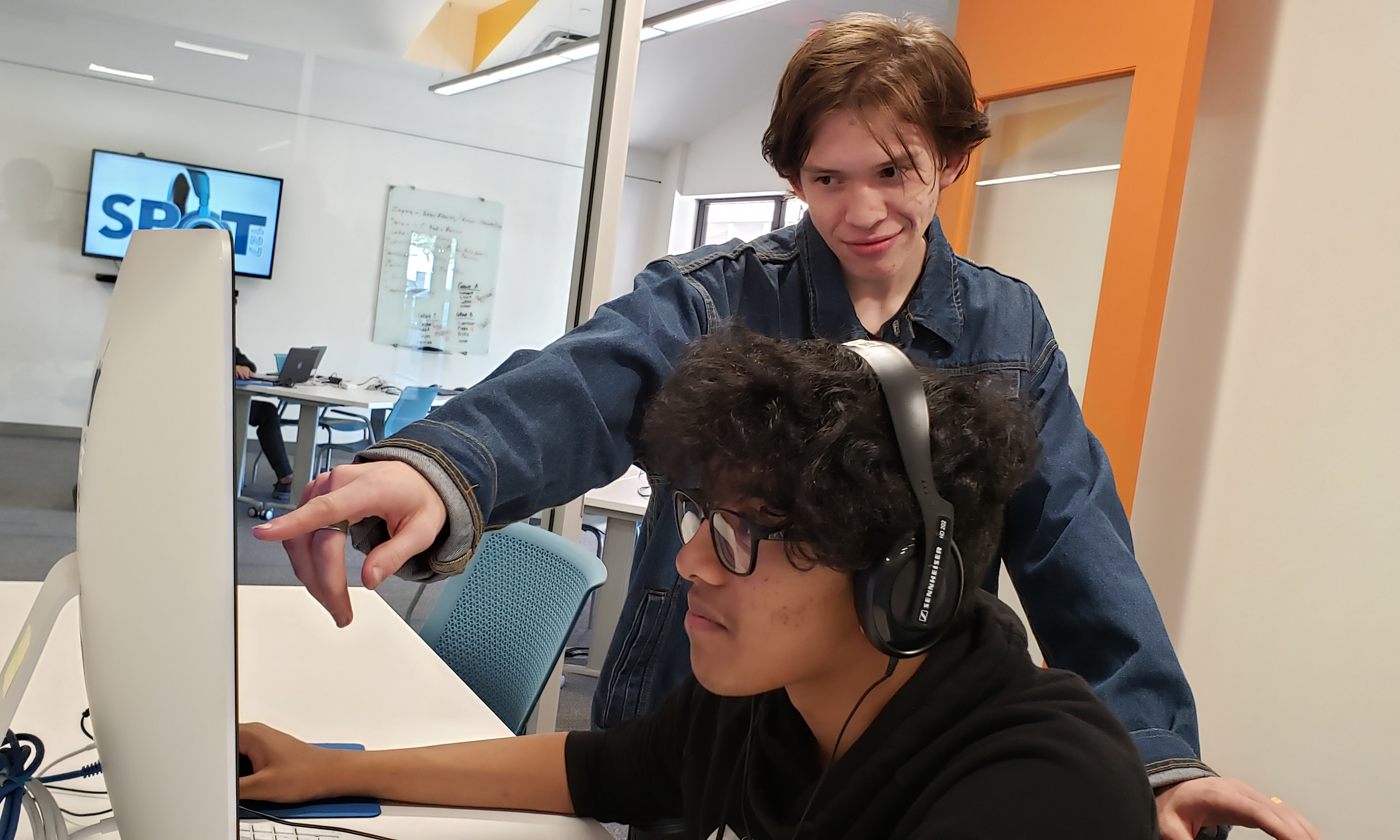 Two SPOT students working at a computer together.